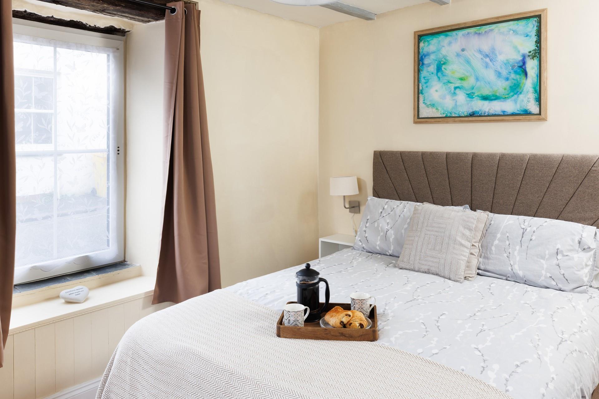 Muted tones and a large, comfortable bed make the bedroom a soothing place to unwind before drifting off to sleep.