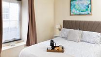 Muted tones and a large, comfortable bed make the bedroom a soothing place to unwind before drifting off to sleep.