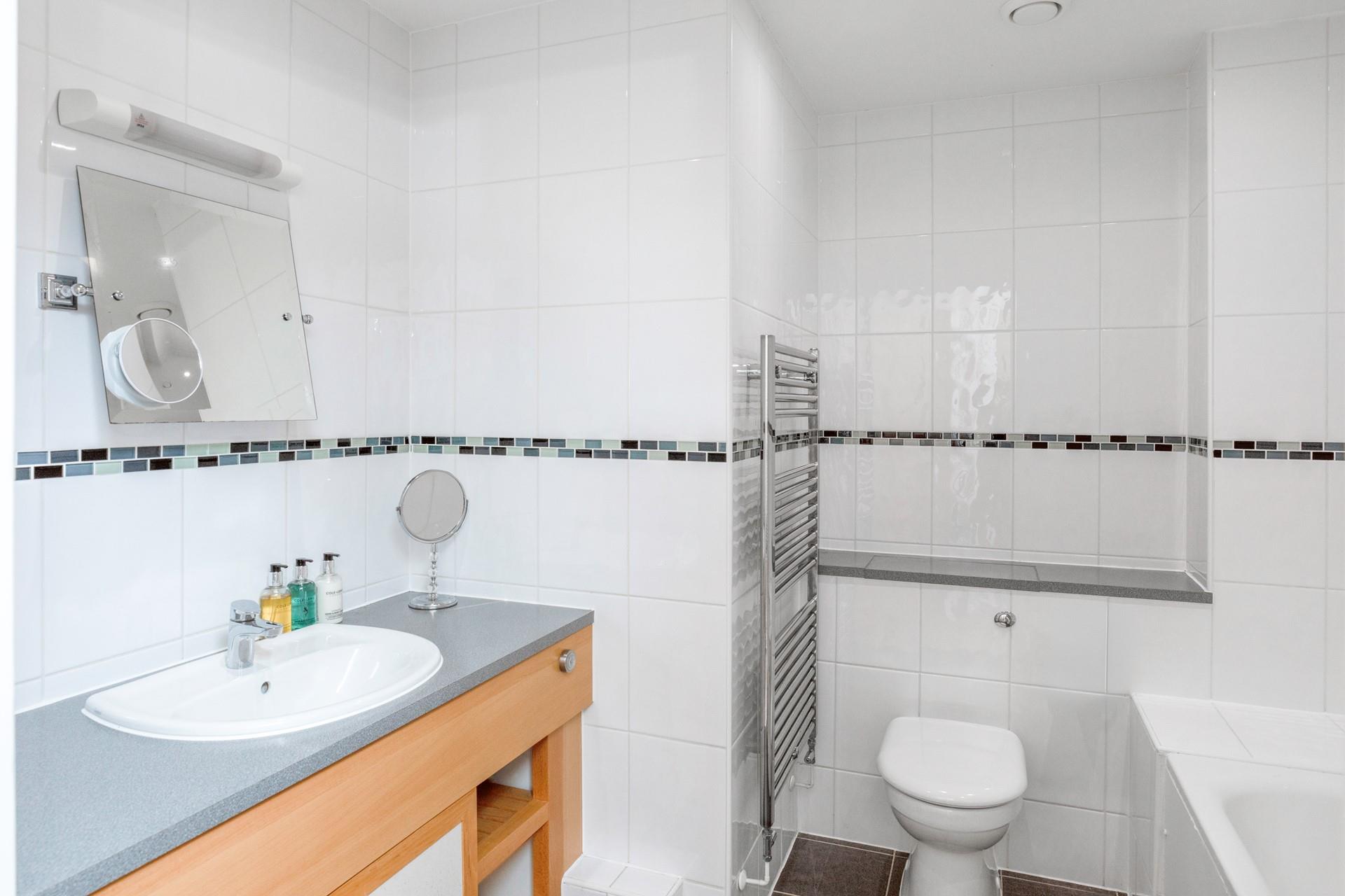 The spacious family bathroom has both a shower and bath.