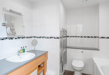 The spacious family bathroom has both a shower and bath.