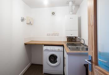 The utility area has a sink, plenty of worktops and a washing machine.