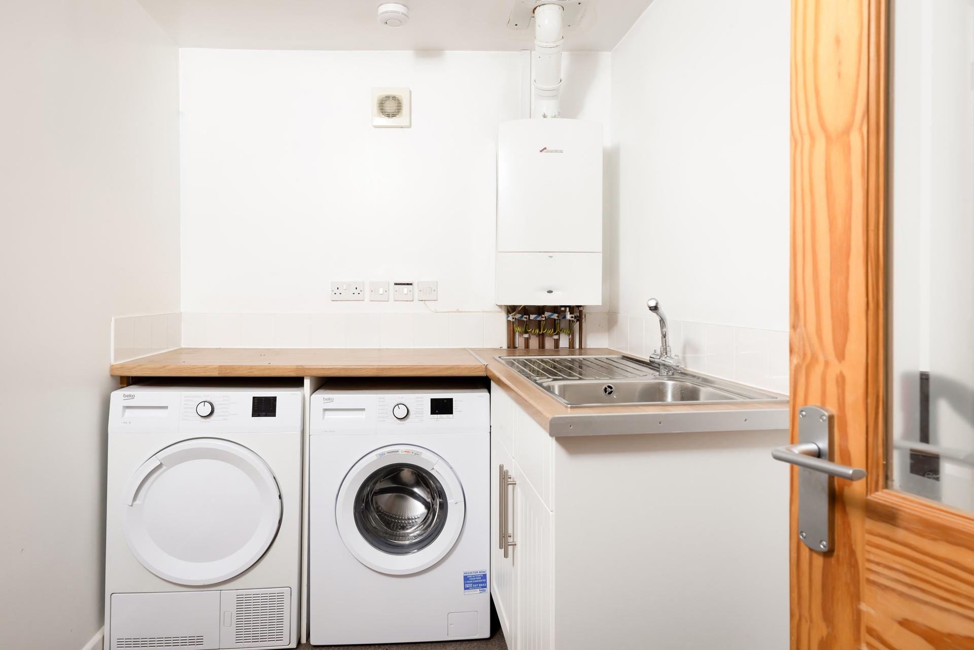 The utility area has a sink, plenty of worktops and a washing machine.
