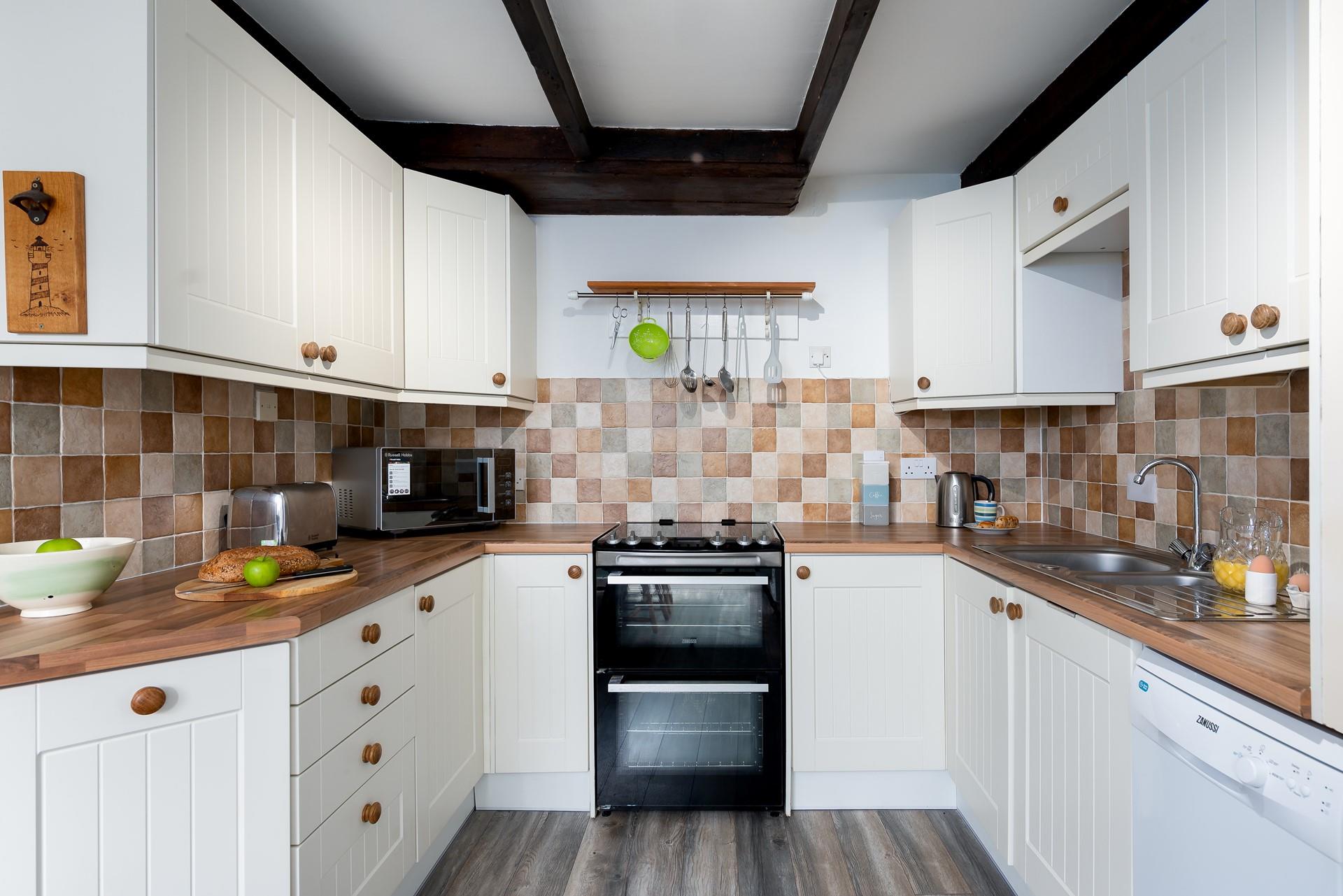 The kitchen has a farmhouse, country chic design, ensuring it is a homely and welcoming space to cook in.