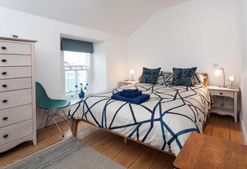 Modern and stylish with exposed floorboards, bedroom 1 offers sea views from the window. 