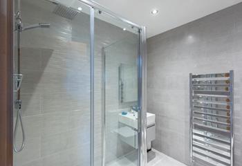 The luxurious family shower room is on the ground floor, with rainfall showerhead and underfloor heating. 