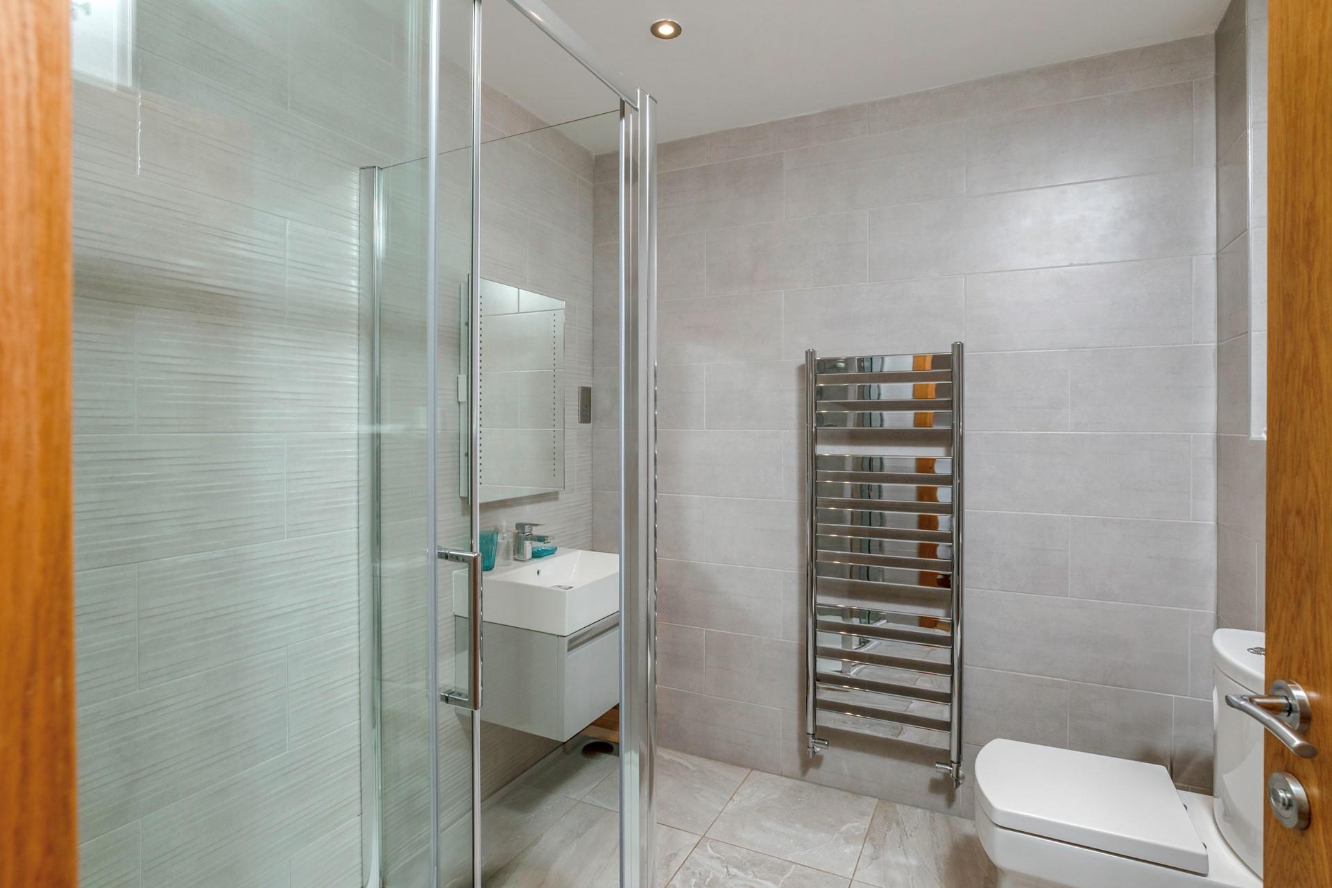 The shower room boasts a luxurious rainfall shower, perfect for washing away beach days!