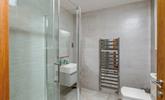 The shower room boasts a luxurious rainfall shower, perfect for washing away beach days! - Thumbnail Image
