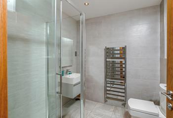 The shower room boasts a luxurious rainfall shower, perfect for washing away beach days!