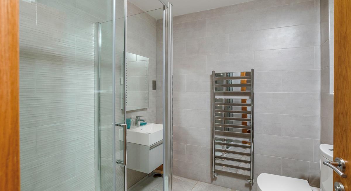 The shower room boasts a luxurious rainfall shower, perfect for washing away beach days!