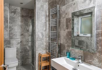 The marble effect tiles and modern fixtures give the ensuite an indulgent, spa-like feel.