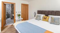 Step from the comfortable bed and into the stylish en suite.