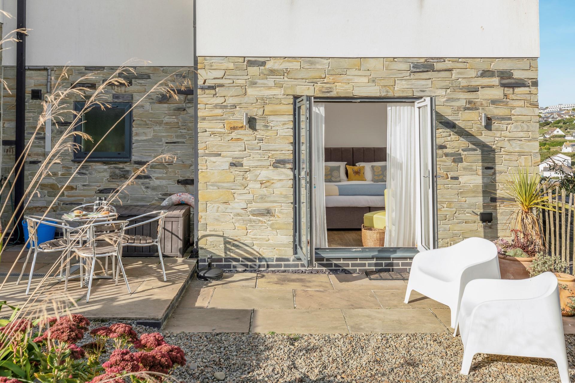 Bedroom 1 is at the back of the house, with doors leading out into the garden. 