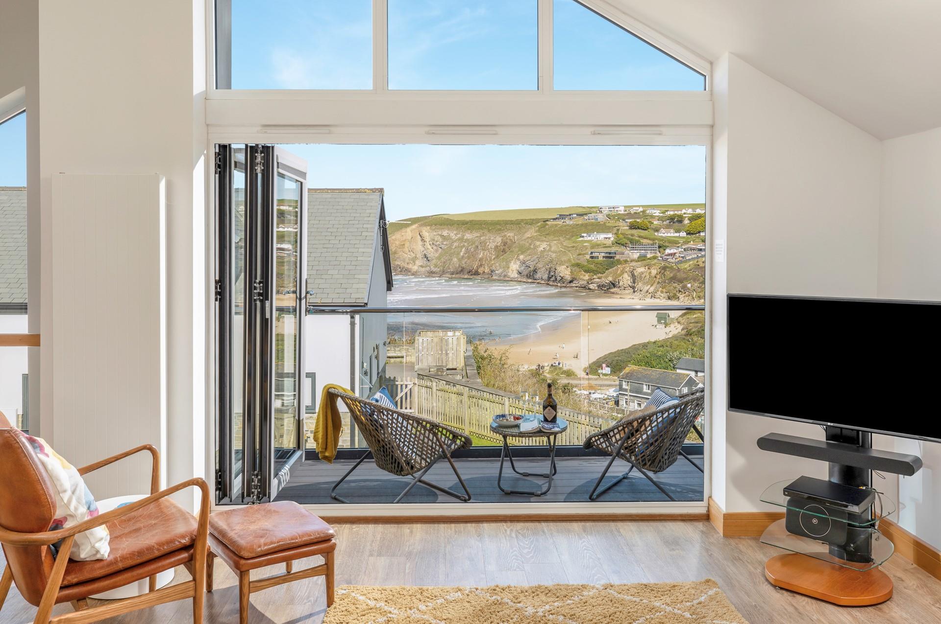 Bi-fold doors lead out from the open plan living space showcasing the views.