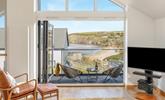 Bi-fold doors lead out from the open plan living space showcasing the views. - Thumbnail Image