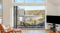 Bi-fold doors lead out from the open plan living space showcasing the views.