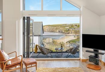 Bi-fold doors lead out from the open plan living space showcasing the views.