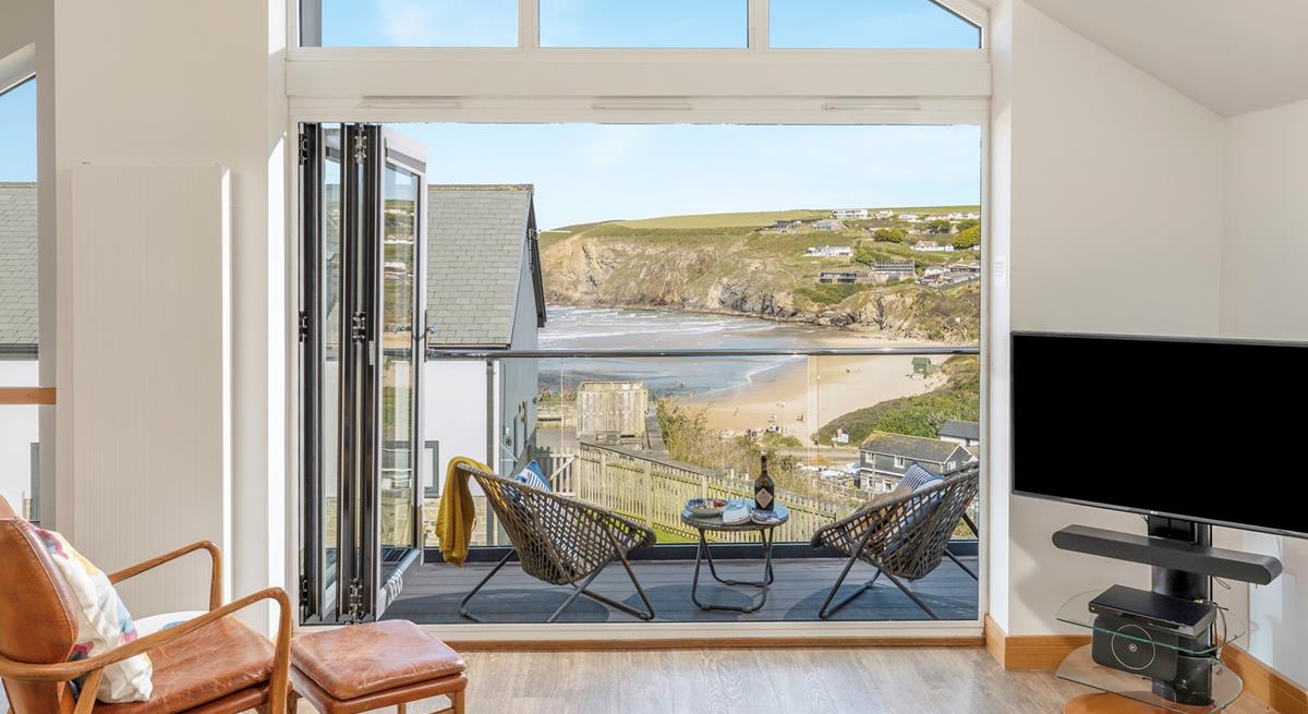 Bi-fold doors lead out from the open plan living space showcasing the views.