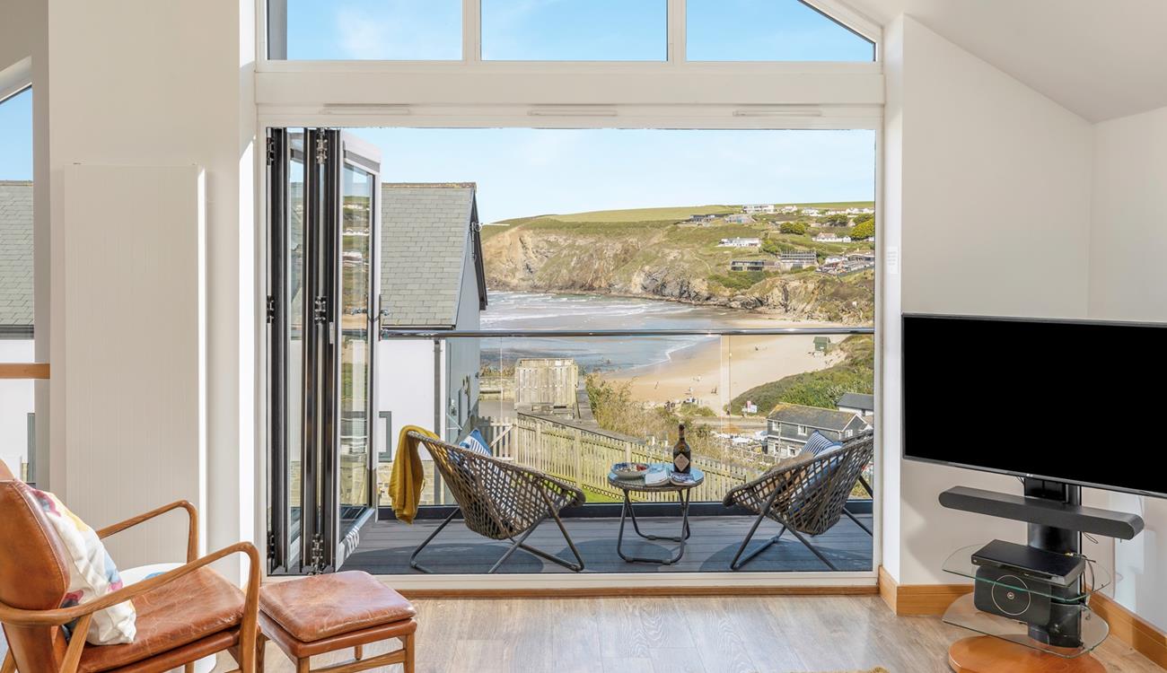 Bi-fold doors lead out from the open plan living space showcasing the views.