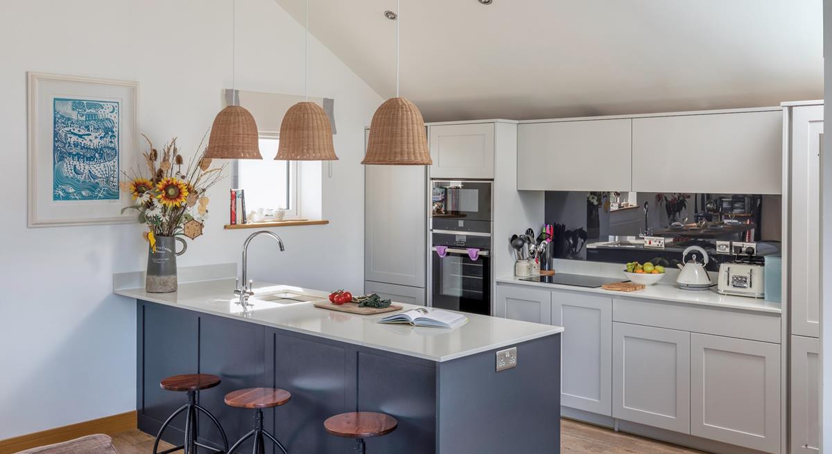 The kitchen is ideal for cooking and socialising with the modern breakfast bar.