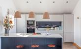 The sleek and stylish kitchen provides all you need for cooking delicious holiday meals. - Thumbnail Image