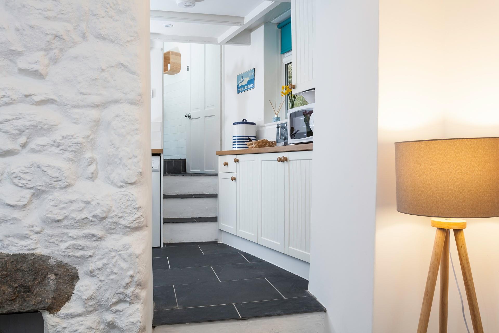 Three steps lead from the lounge area into the modern kitchen. 