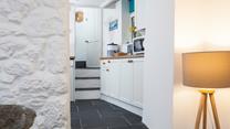 Three steps lead from the lounge area into the modern kitchen. 