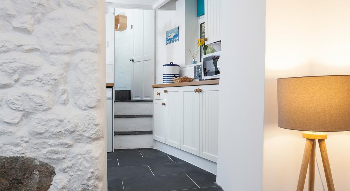Three steps lead from the lounge area into the modern kitchen. 