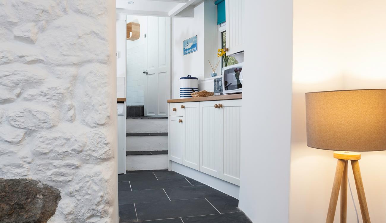 Three steps lead from the lounge area into the modern kitchen. 