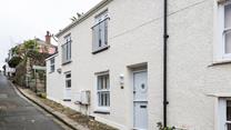 The property has a traditional stable door with a quirky porthole window to reflect its seaside location.