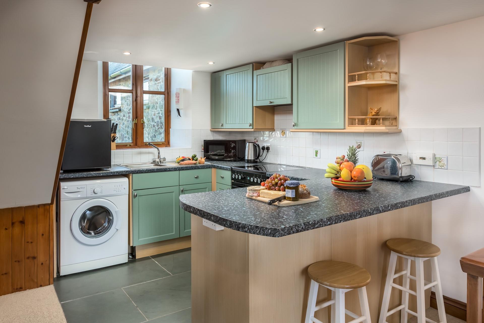 The open plan kitchen area is well-equipped with all you need to rustle up tasty meals.