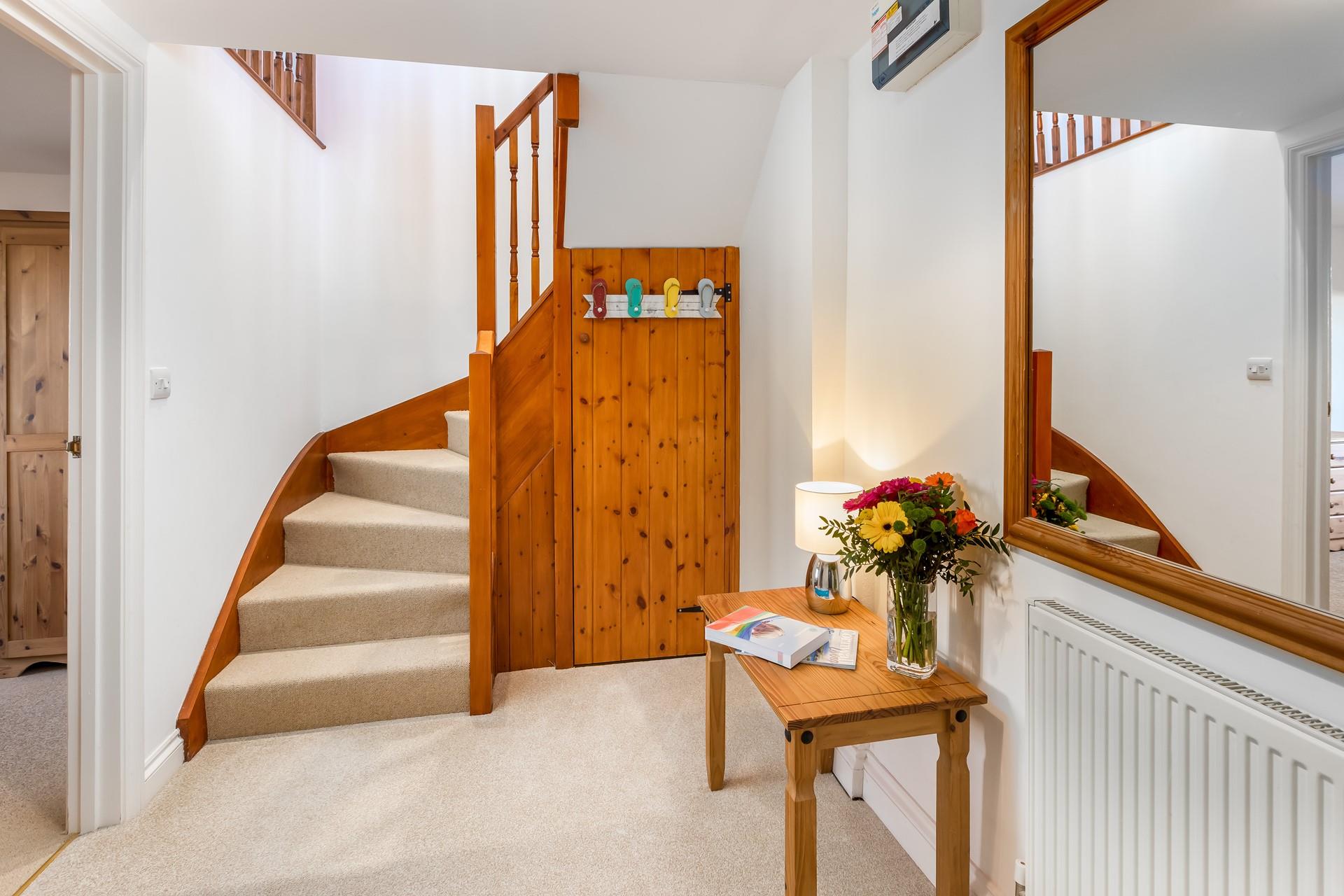 Under stair storage is handy for popping coats or beach gear away.