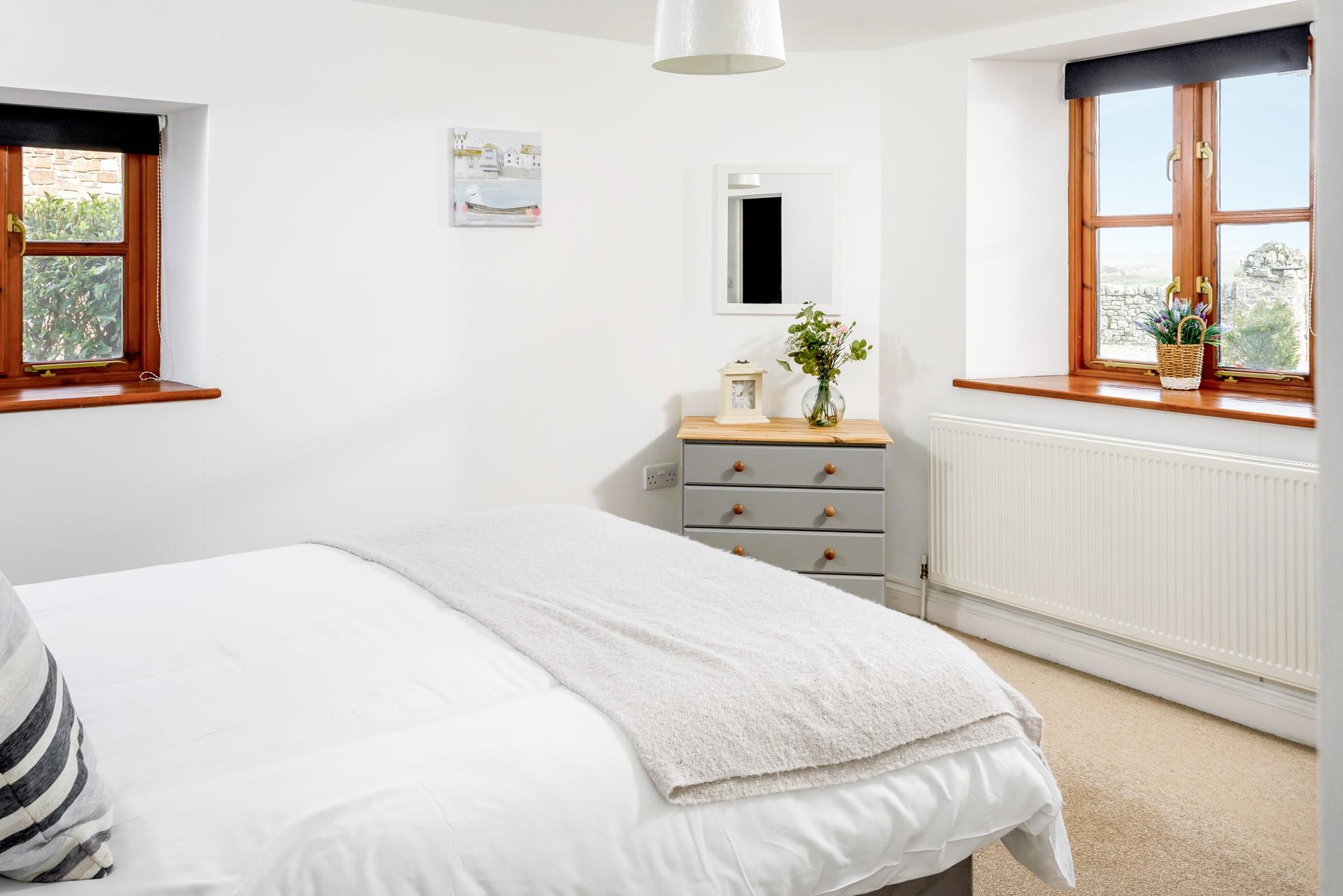 With its soothing neutral tones, the main bedroom is the perfect place to unwind and get a peaceful night's sleep after a day of exploring.