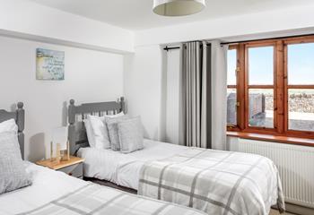 Calming grey decor makes the twin bedroom a real home from home, perfect for children and young adults.