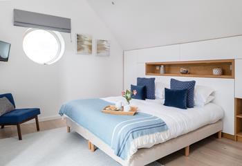 Nautical touch to the master bedroom with a porthole window.