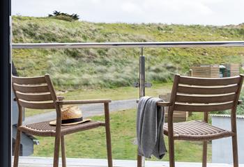 Indulge in a good book on the private balcony overlooking the sand dunes.