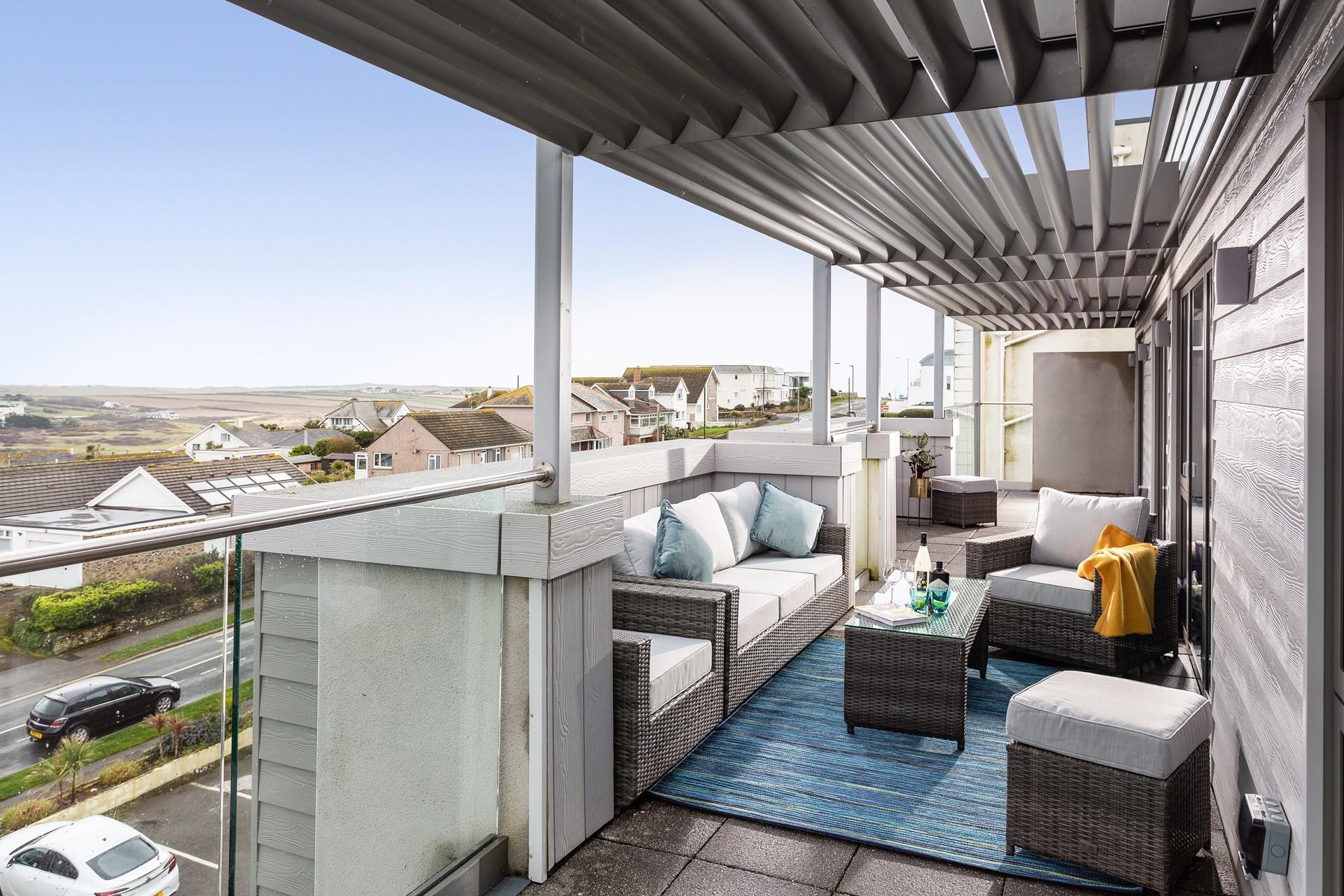 Enjoy the morning sunshine on the front balcony, with comfortable lounge seating and lovely views. 