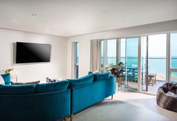 The open plan living area opens out onto the balcony, where you can watch the waves and listen to the sea.