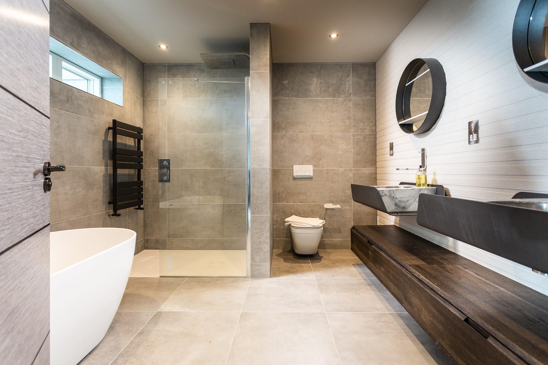 The master en suite is utterly luxurious, with a gorgeously deep free-standing bath, as well as a huge rainfall shower.