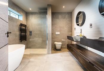 The master en suite is utterly luxurious, with a gorgeously deep free-standing bath, as well as a huge rainfall shower.