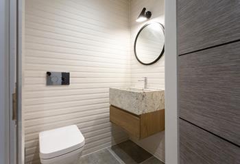 The modern cloakroom features a WC and a basin.