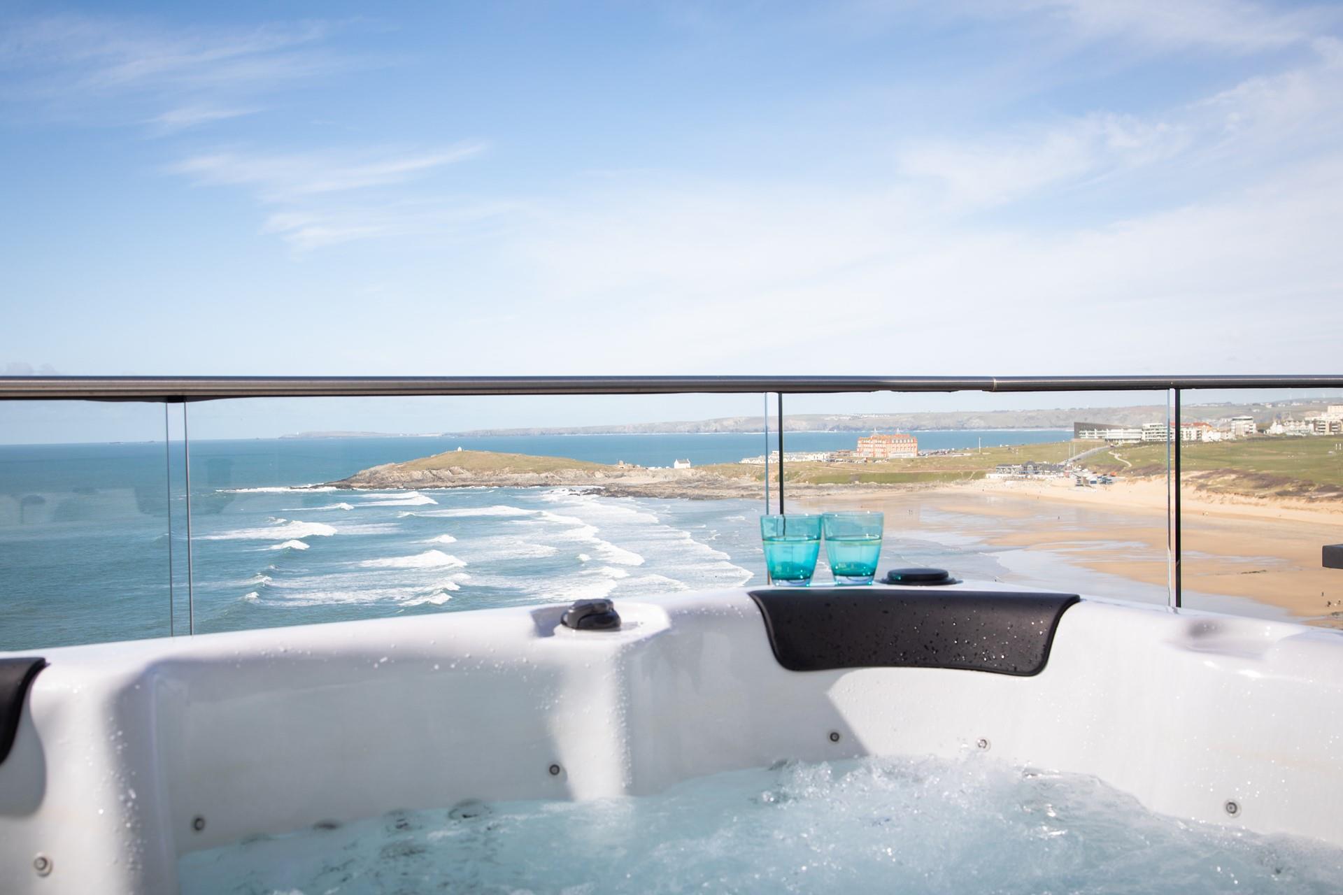 Dip into the hot tub and enjoy the stunning views with a glass of wine in hand.