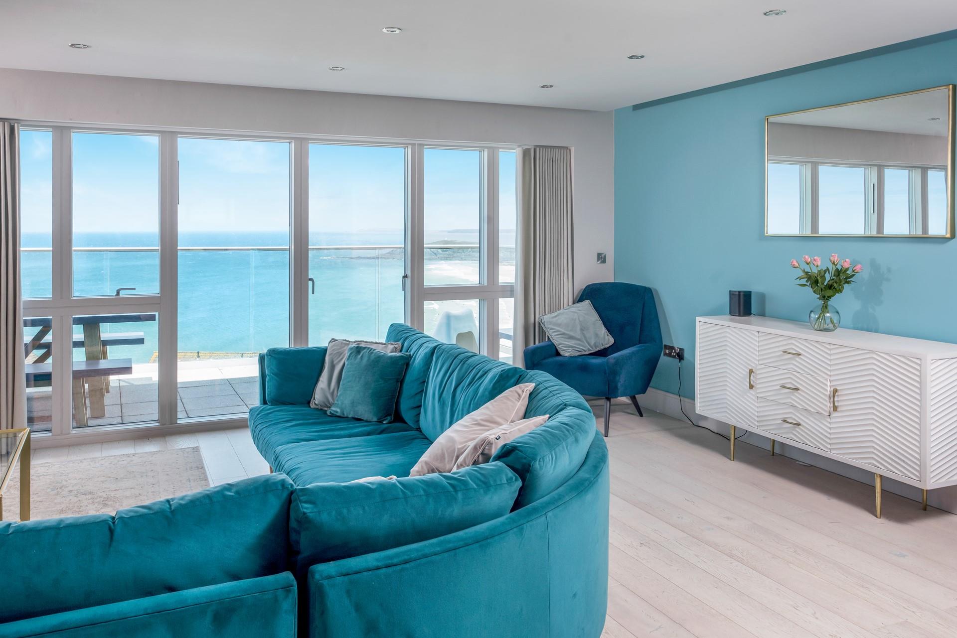 Sink into the plush blue sofa and relax after a day on the beach.