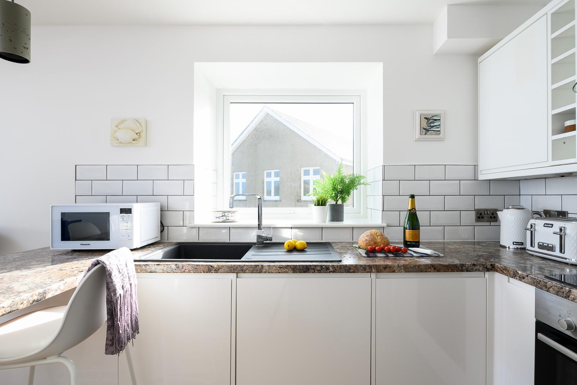 Sleek and stylish, the kitchen is fully equipped with modern appliances to make cooking a breeze.