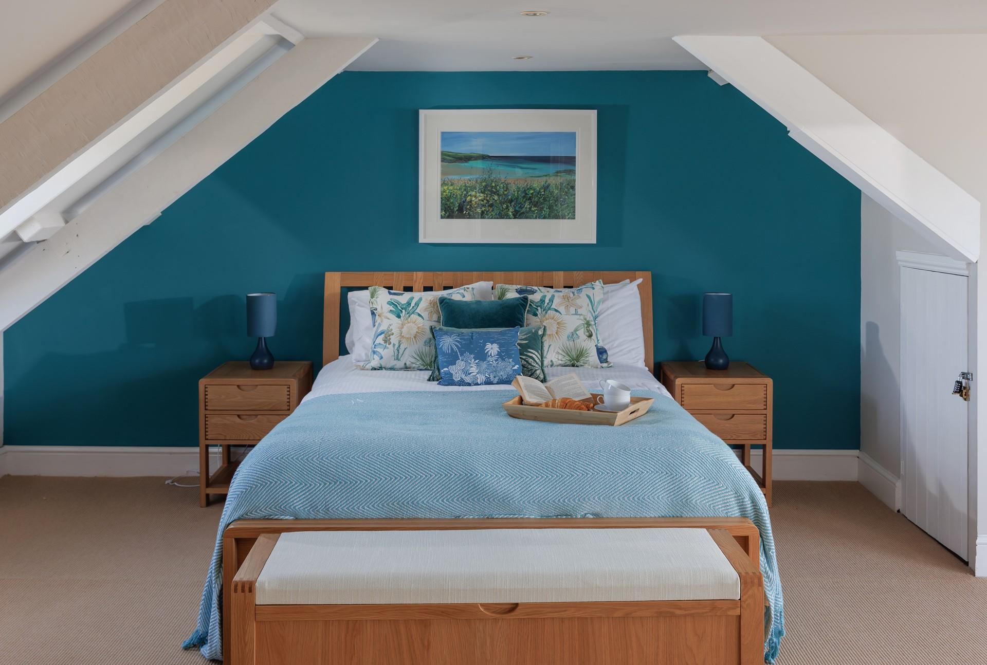 The master bedroom at the top of the house, is spacious and light with views towards the dunes.