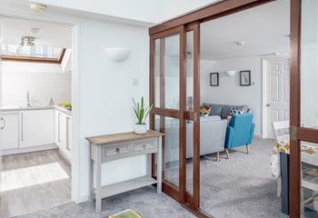 The spacious hallway connects the living area, kitchen and two of the bedrooms.