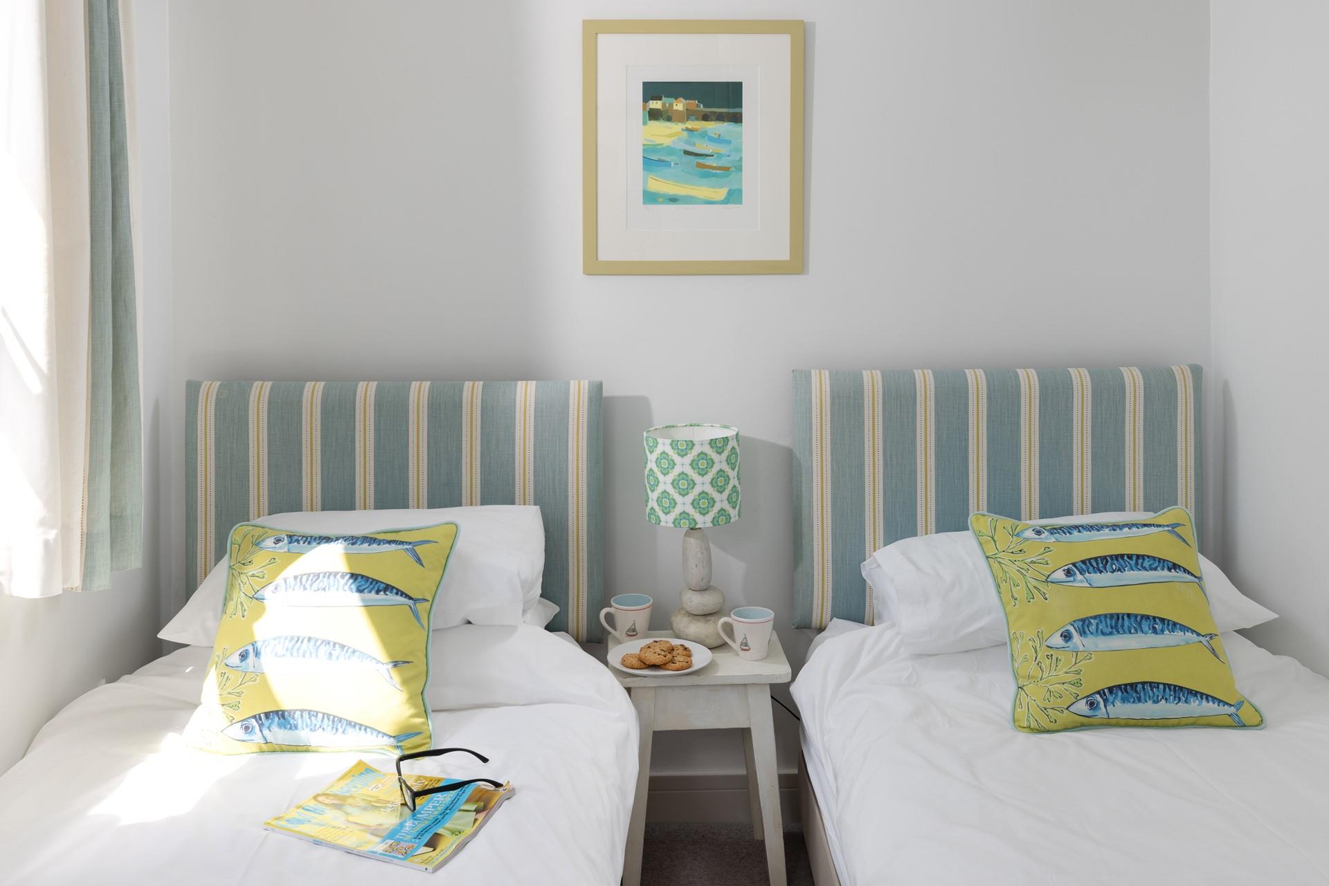 We love the coastal style in the twin bedroom with nautical stripes.