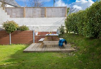 The garden is fully enclosed for children and dogs to play safely.