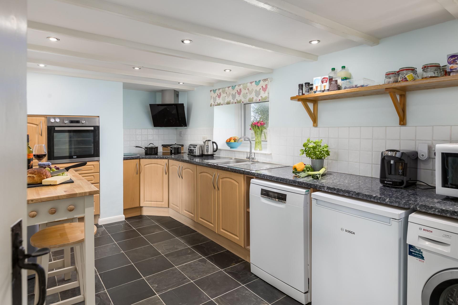 The kitchen is spacious and fully equipped for all your cooking needs.