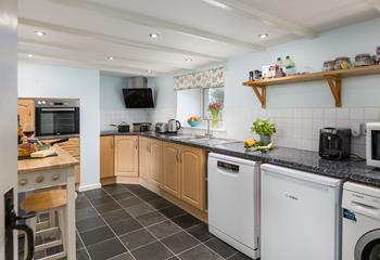 The kitchen is spacious and fully equipped for all your cooking needs.