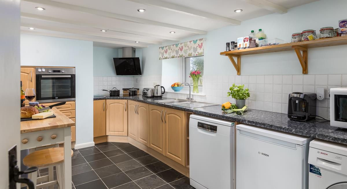 The kitchen is spacious and fully equipped for all your cooking needs.